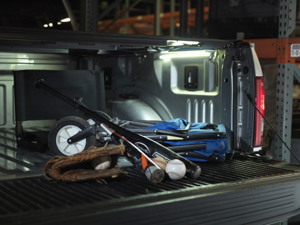 Truck bed lighting kit shining light on baseball equipment at night Truck bed lighting kit shining light on baseball equipment at night